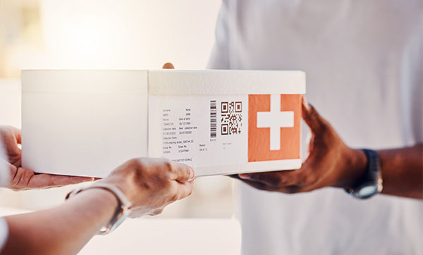 person receiving a package with a red cross and QR code related to health delivery services for eight items or products